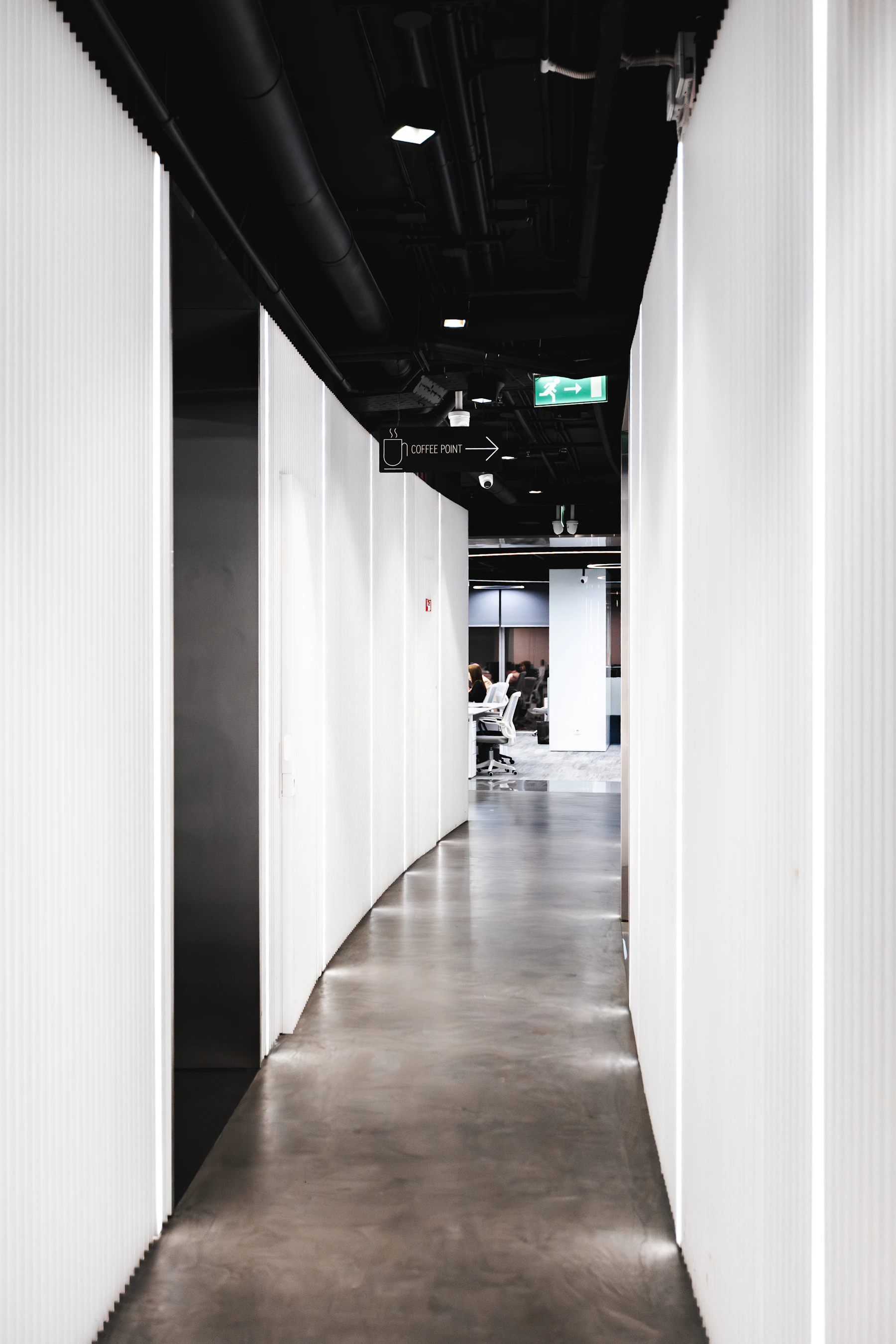 A minimalist corridor leading into a contemporary office
