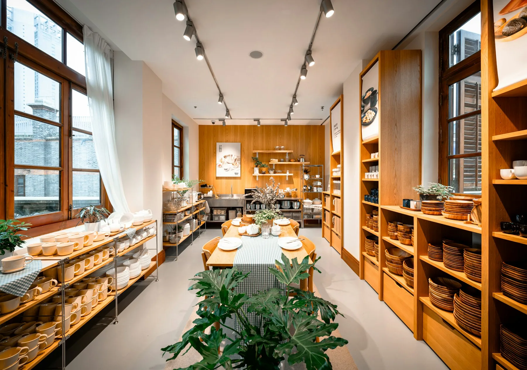 Ceramics and kitchenware arranged on a display table in a contemporary retail store