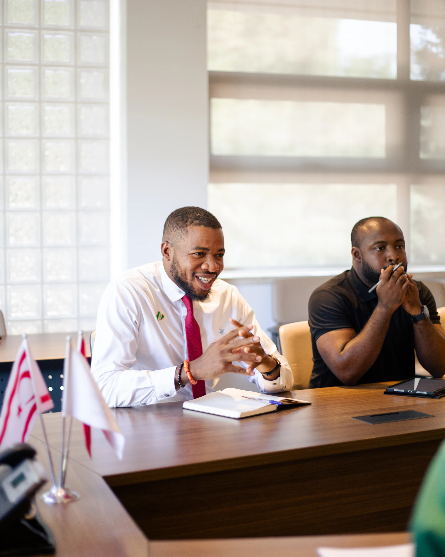 Two business professionals discussing a presentation at a conference table