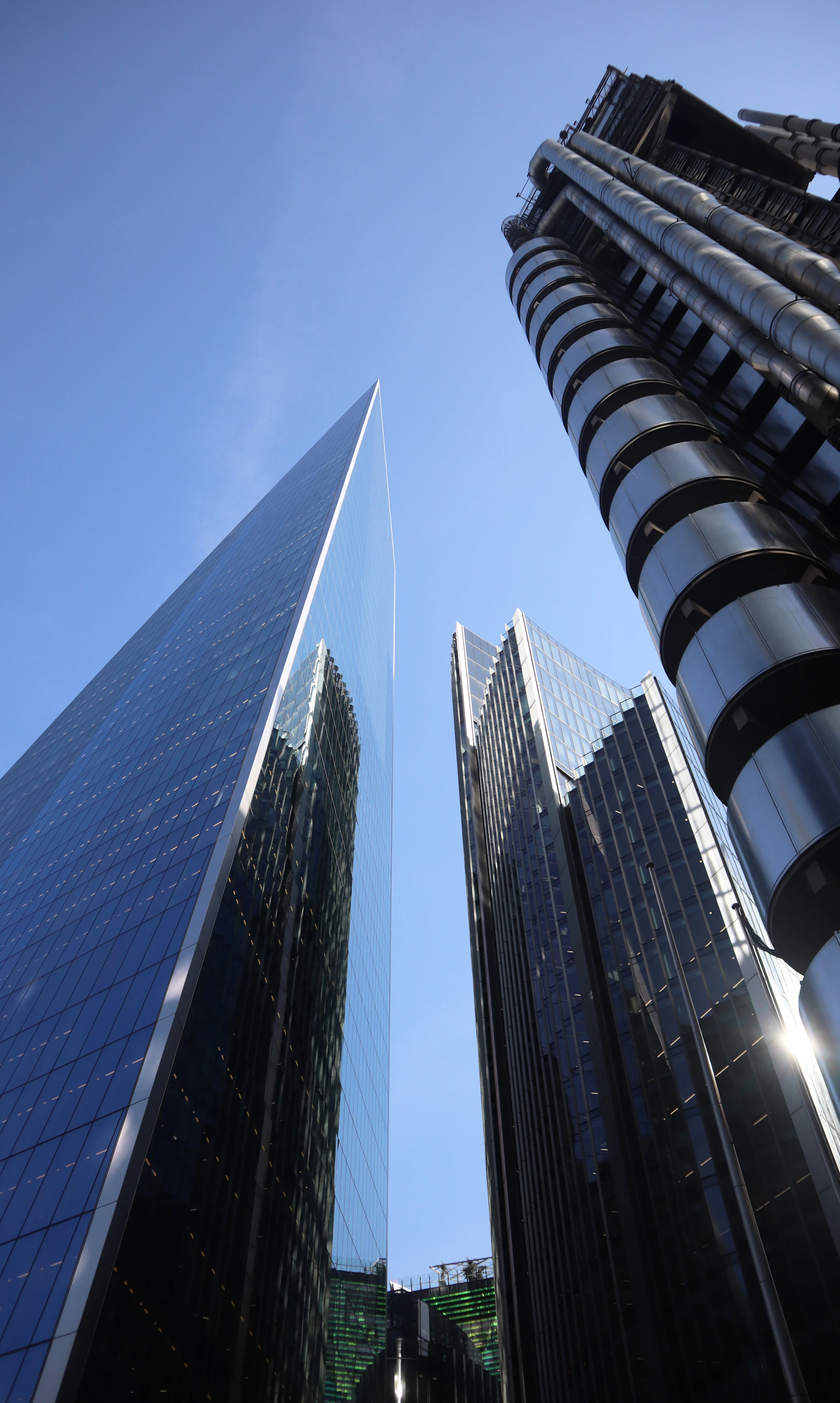 Upward view between glass skyscrapers in the City of London